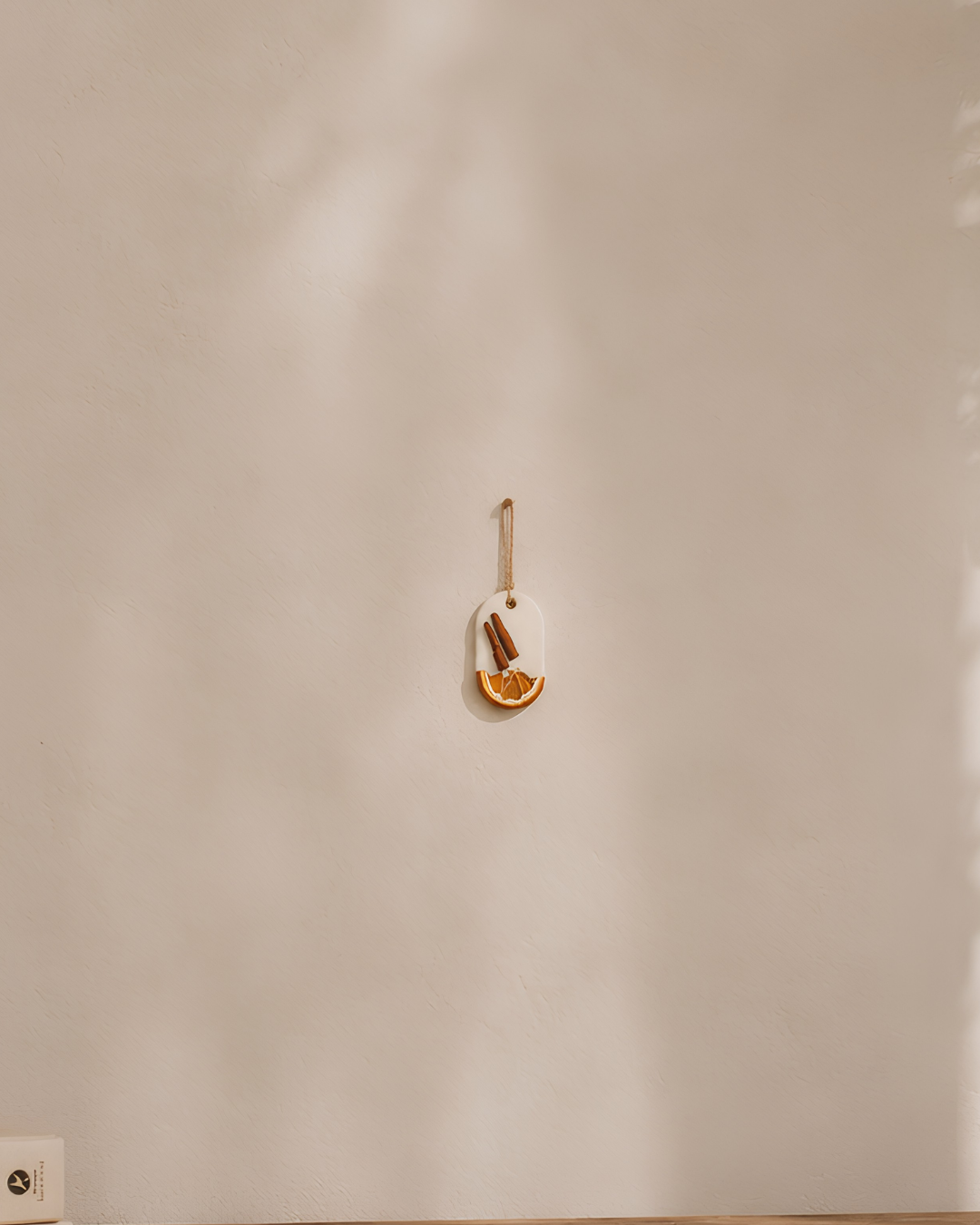Fragnam Lemon Bark Hanging air freshener with lemon scent, featuring a decorative bark design and hanging string.