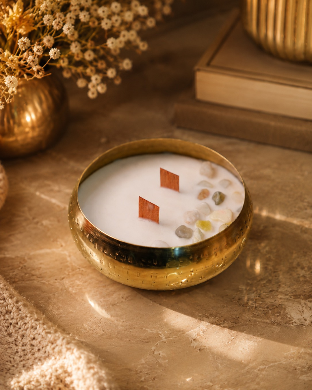 Fragnam Swarna Aura Candle with golden decorative design and elegant glass holder, showcasing a warm, inviting glow.
