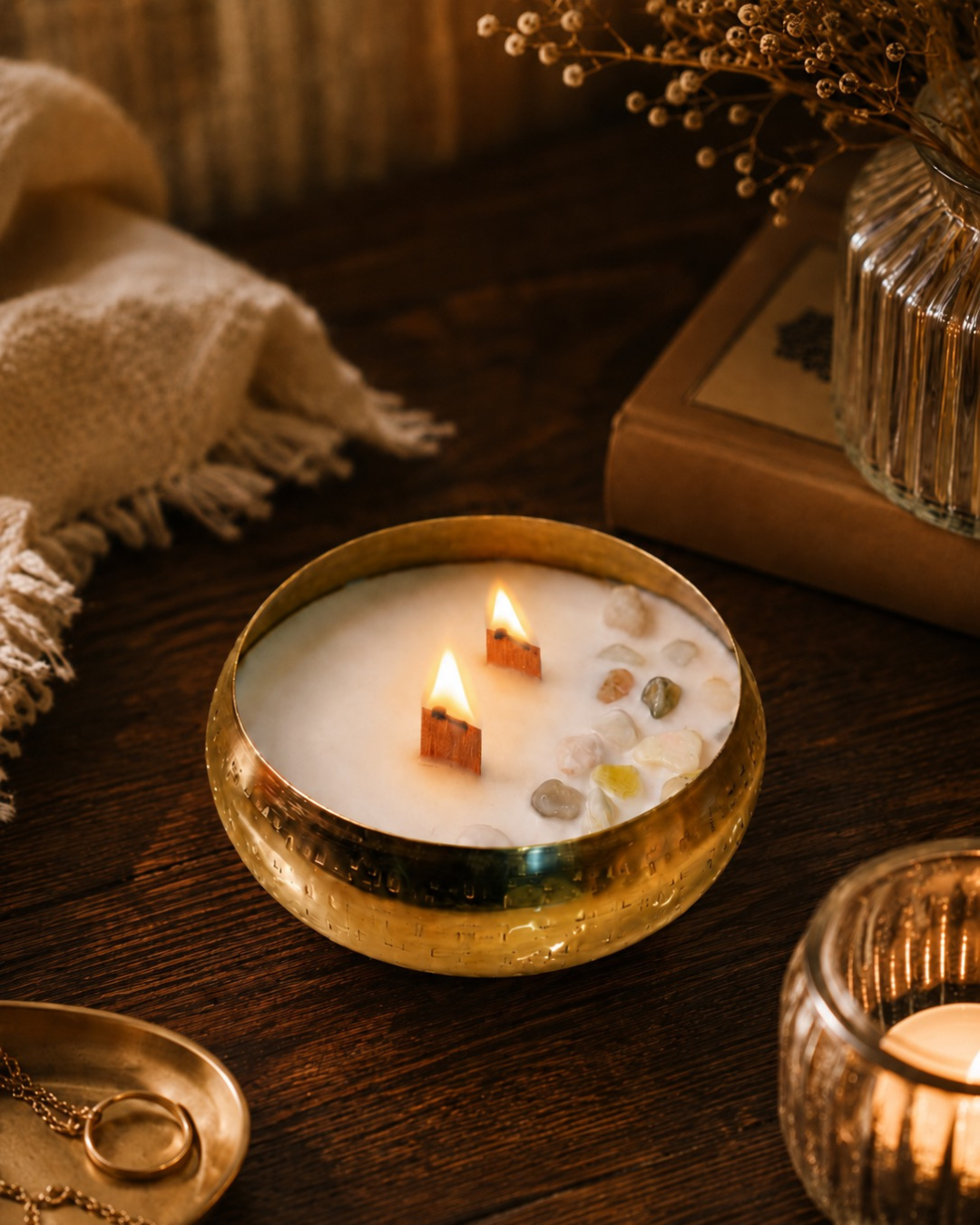 Fragnam Swarna Aura Candle with a golden decorative holder and soft glowing light, perfect for ambiance and home decor.